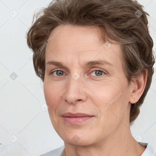 Joyful white adult female with short  brown hair and grey eyes