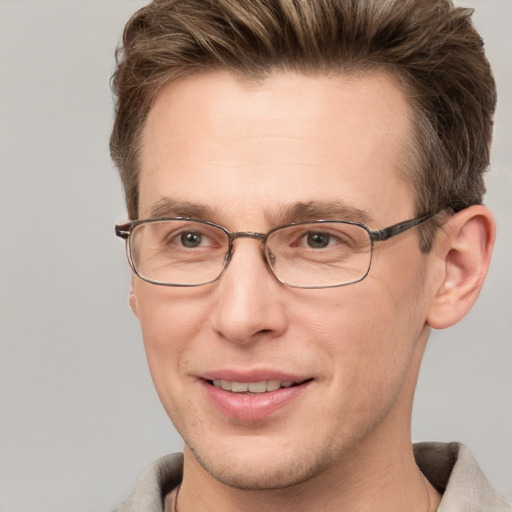 Joyful white adult male with short  brown hair and grey eyes