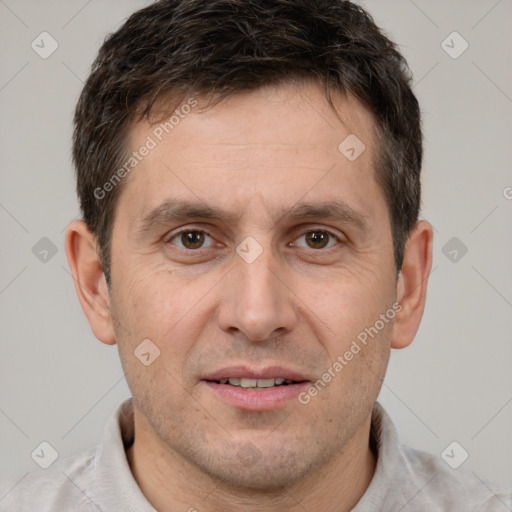 Joyful white adult male with short  brown hair and brown eyes