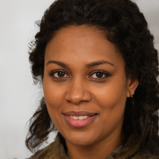 Joyful black young-adult female with medium  brown hair and brown eyes