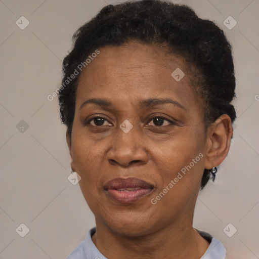 Joyful black adult female with short  black hair and brown eyes