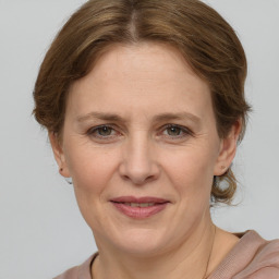 Joyful white adult female with medium  brown hair and grey eyes