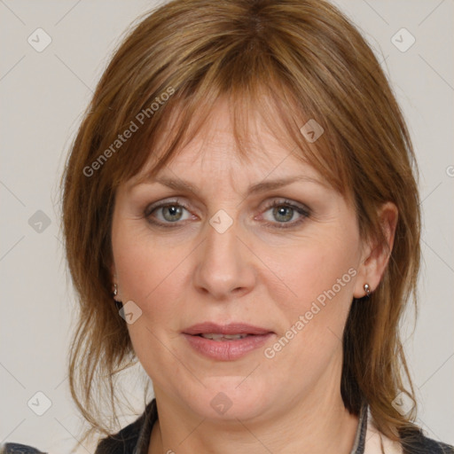 Joyful white adult female with medium  brown hair and grey eyes