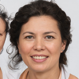 Joyful white adult female with medium  brown hair and brown eyes