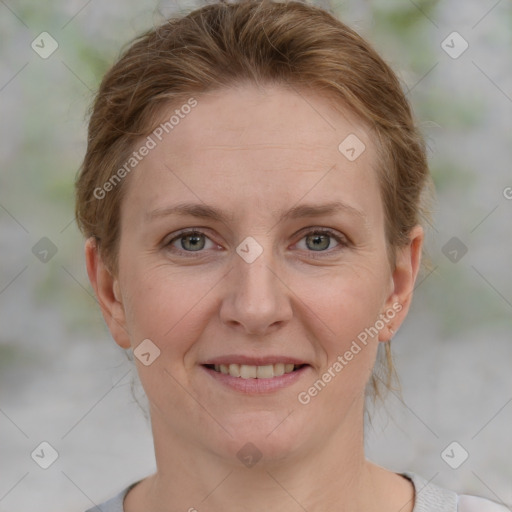 Joyful white adult female with short  brown hair and grey eyes