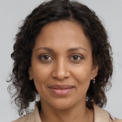 Joyful black adult female with medium  brown hair and brown eyes