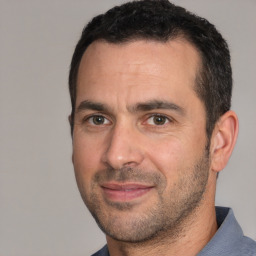 Joyful white adult male with short  brown hair and brown eyes