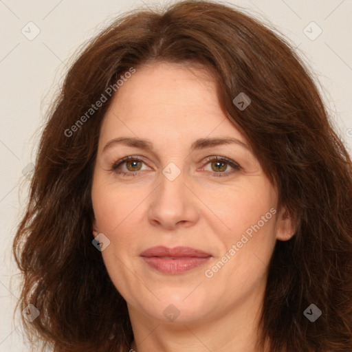 Joyful white adult female with long  brown hair and brown eyes