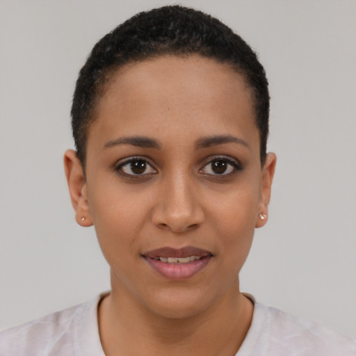 Joyful latino young-adult female with short  black hair and brown eyes