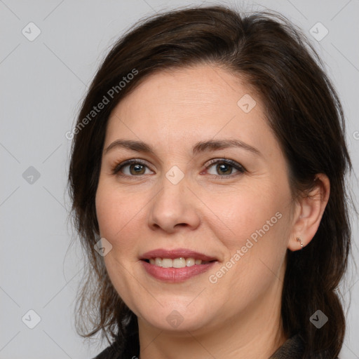 Joyful white adult female with medium  brown hair and brown eyes