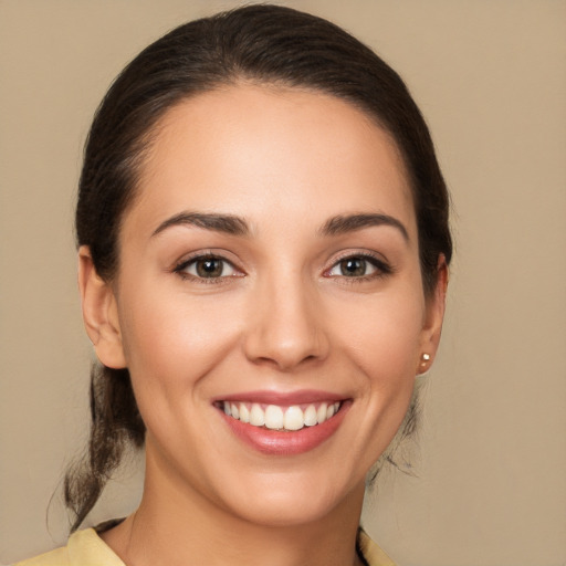 Joyful white young-adult female with medium  brown hair and brown eyes