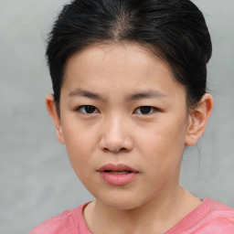 Joyful asian child female with short  brown hair and brown eyes