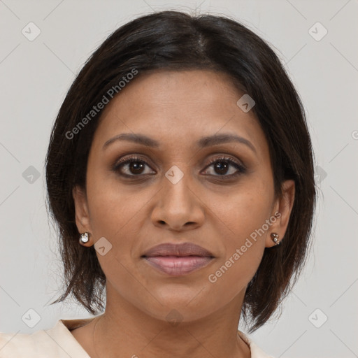 Joyful black adult female with medium  brown hair and brown eyes