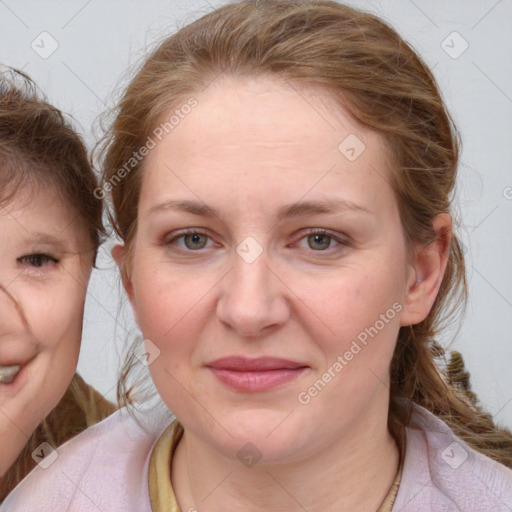 Joyful white young-adult female with medium  brown hair and blue eyes