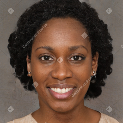 Joyful black young-adult female with long  black hair and brown eyes