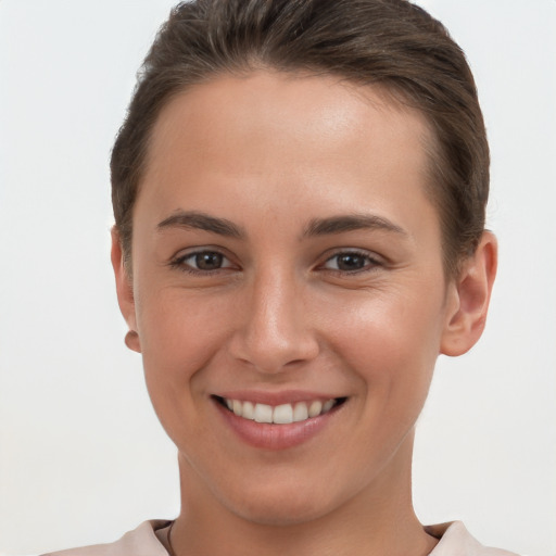 Joyful white young-adult female with short  brown hair and brown eyes