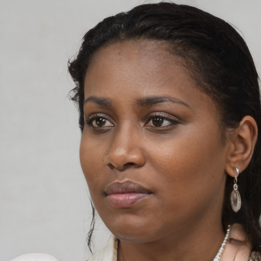 Joyful black young-adult female with medium  brown hair and brown eyes