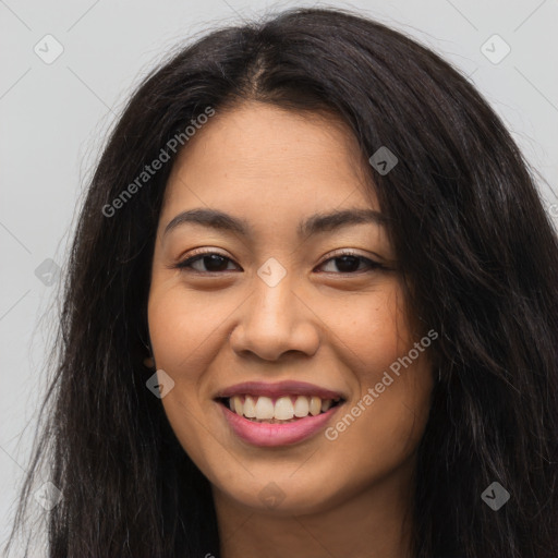 Joyful latino young-adult female with long  brown hair and brown eyes