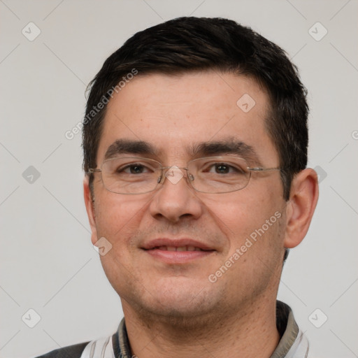 Joyful white adult male with short  black hair and brown eyes