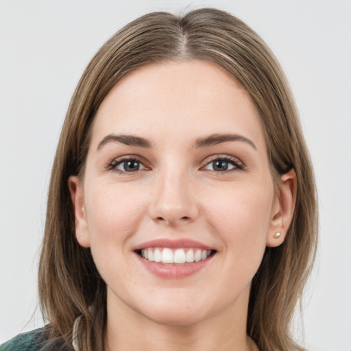 Joyful white young-adult female with long  brown hair and grey eyes