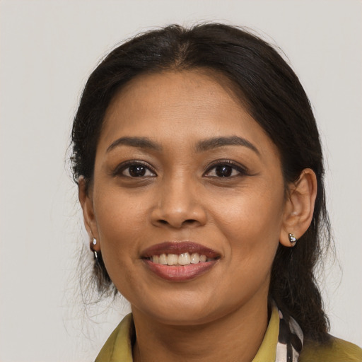 Joyful latino young-adult female with medium  brown hair and brown eyes