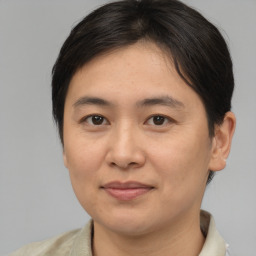 Joyful asian adult female with medium  brown hair and brown eyes