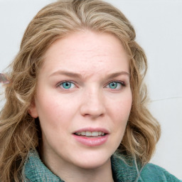 Joyful white young-adult female with long  brown hair and green eyes