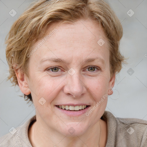 Joyful white adult female with medium  brown hair and blue eyes