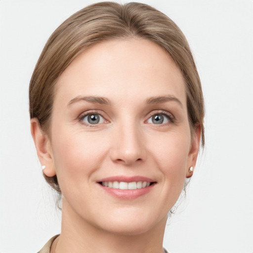 Joyful white young-adult female with short  brown hair and grey eyes