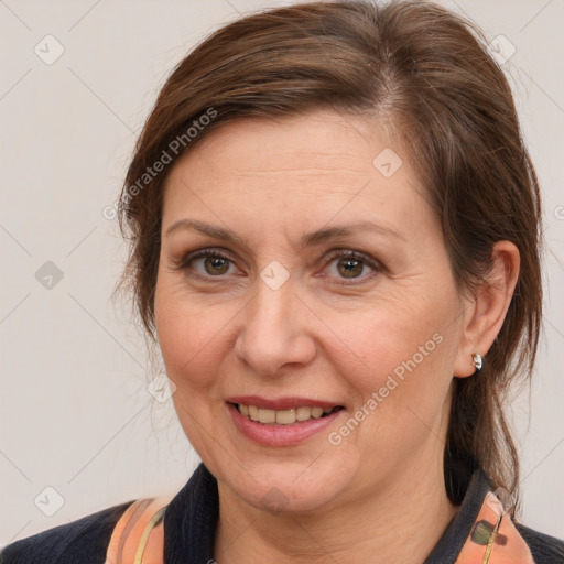 Joyful white adult female with medium  brown hair and brown eyes