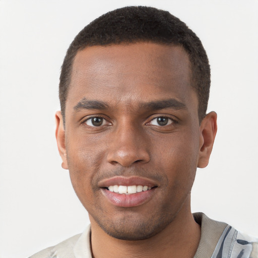 Joyful black young-adult male with short  brown hair and brown eyes