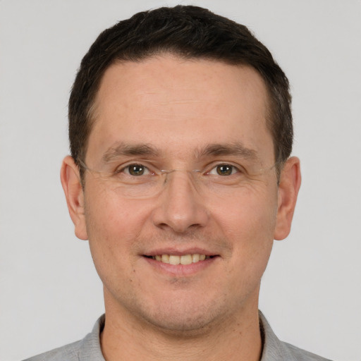 Joyful white adult male with short  brown hair and brown eyes