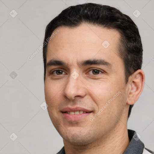 Joyful white young-adult male with short  black hair and brown eyes