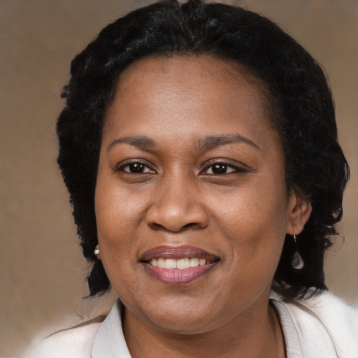 Joyful black adult female with medium  black hair and brown eyes