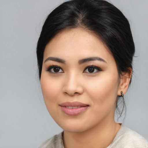 Joyful asian young-adult female with medium  black hair and brown eyes
