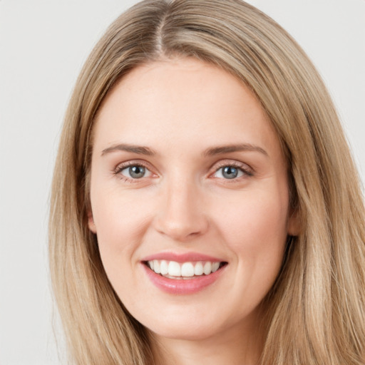 Joyful white young-adult female with long  brown hair and green eyes