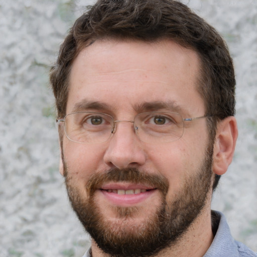 Joyful white adult male with short  brown hair and grey eyes