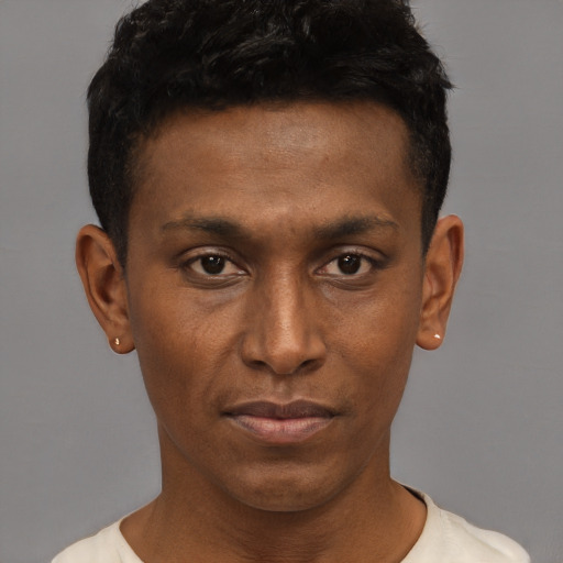 Joyful black young-adult male with short  brown hair and brown eyes