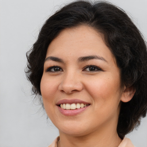 Joyful asian young-adult female with long  brown hair and brown eyes