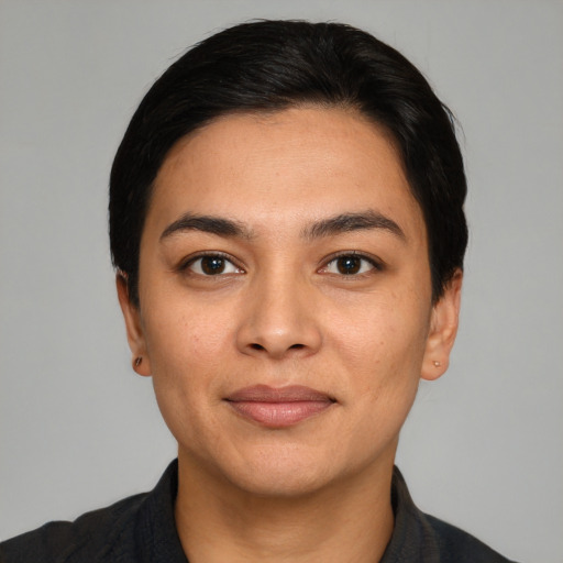 Joyful latino young-adult female with short  black hair and brown eyes