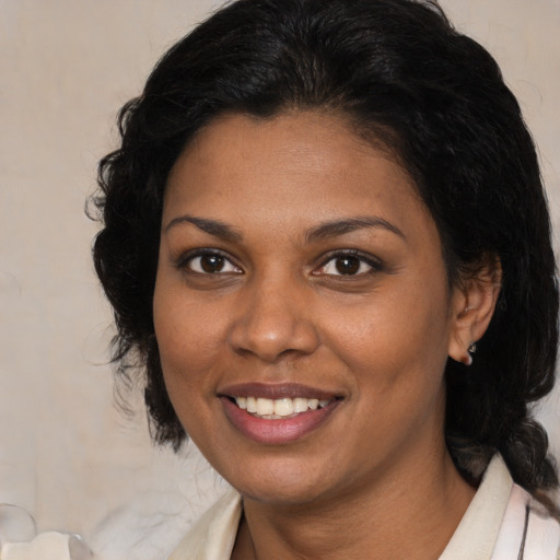 Joyful black young-adult female with medium  brown hair and brown eyes