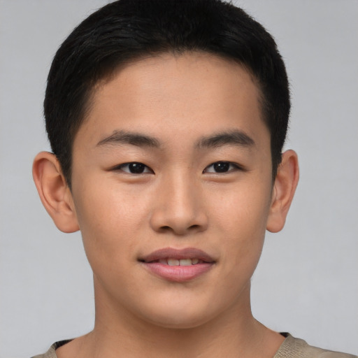 Joyful asian young-adult male with short  brown hair and brown eyes