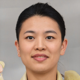 Joyful asian young-adult female with short  black hair and brown eyes