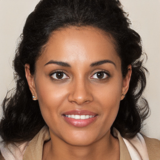 Joyful black young-adult female with medium  brown hair and brown eyes