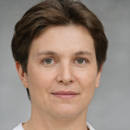 Joyful white adult female with short  brown hair and grey eyes