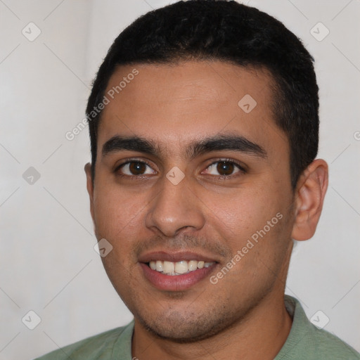 Joyful latino young-adult male with short  black hair and brown eyes