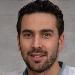 Joyful white young-adult male with short  black hair and brown eyes