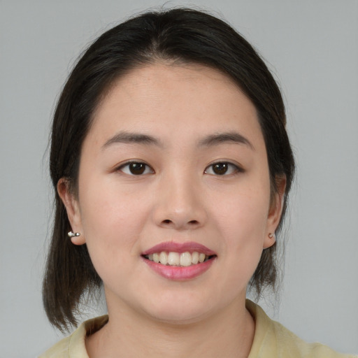 Joyful asian young-adult female with medium  brown hair and brown eyes