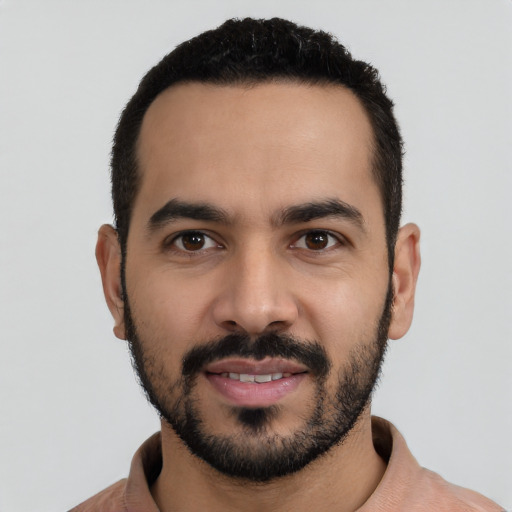 Joyful latino young-adult male with short  black hair and brown eyes