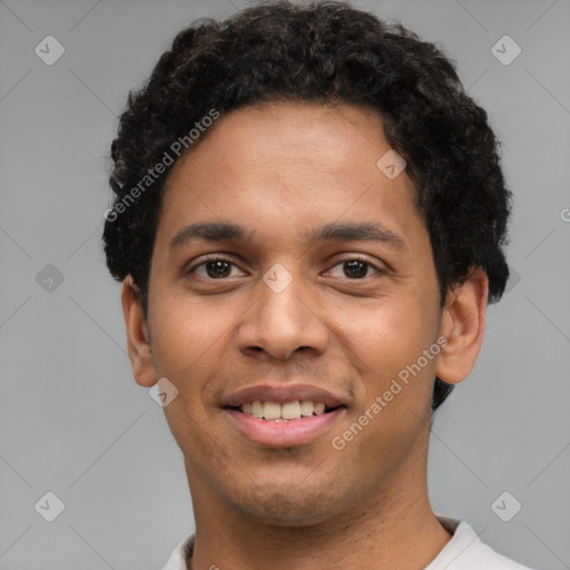 Joyful latino young-adult male with short  brown hair and brown eyes